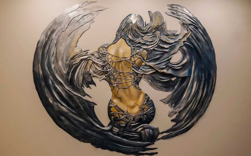 Winged figure in ornament — full design