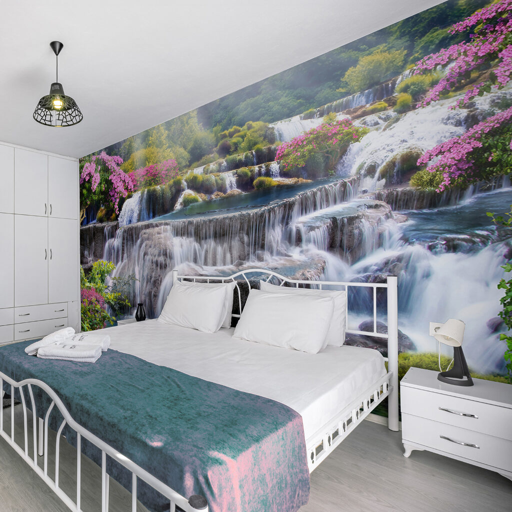 Waterfall between pink shrubs — interior 11